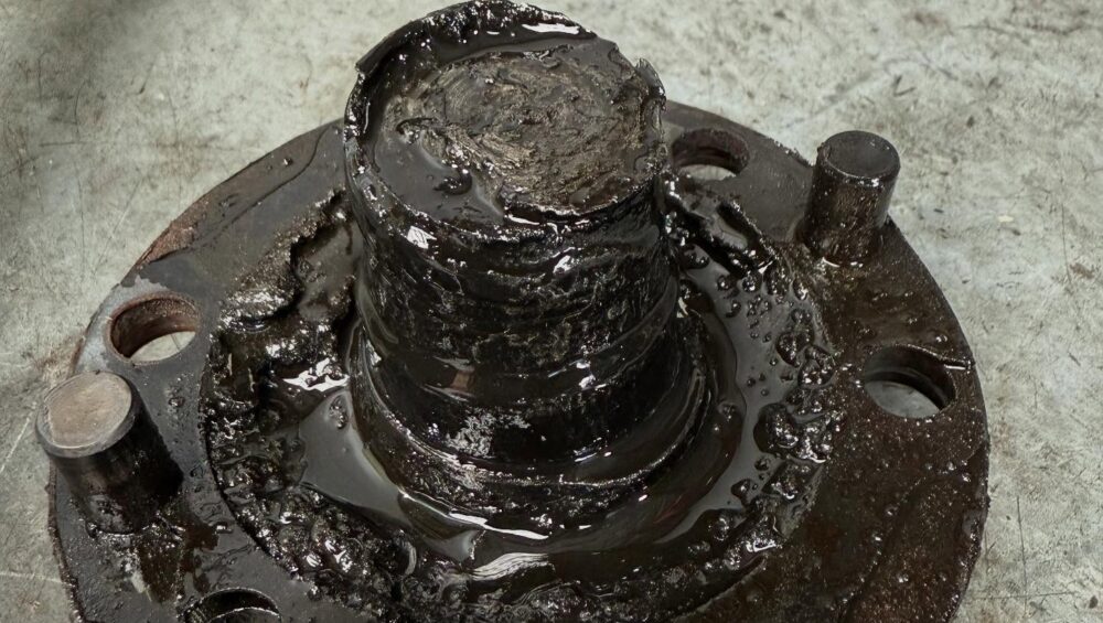 Broken axle shaft and hub from a Toyota LandCruiser covered in old grease