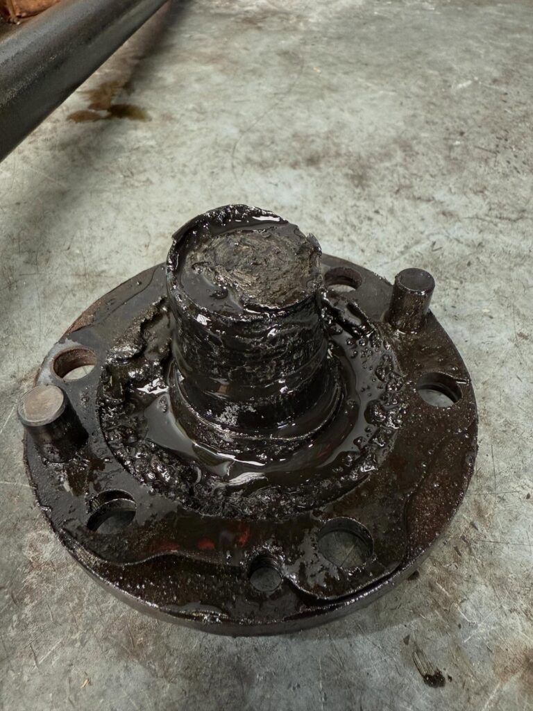 Broken axle shaft and hub from a Toyota LandCruiser covered in old grease