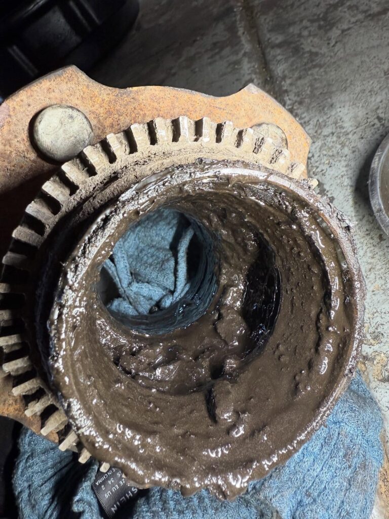 Wheel bearing grease that has broken down into sludge inside a LandCruiser hub