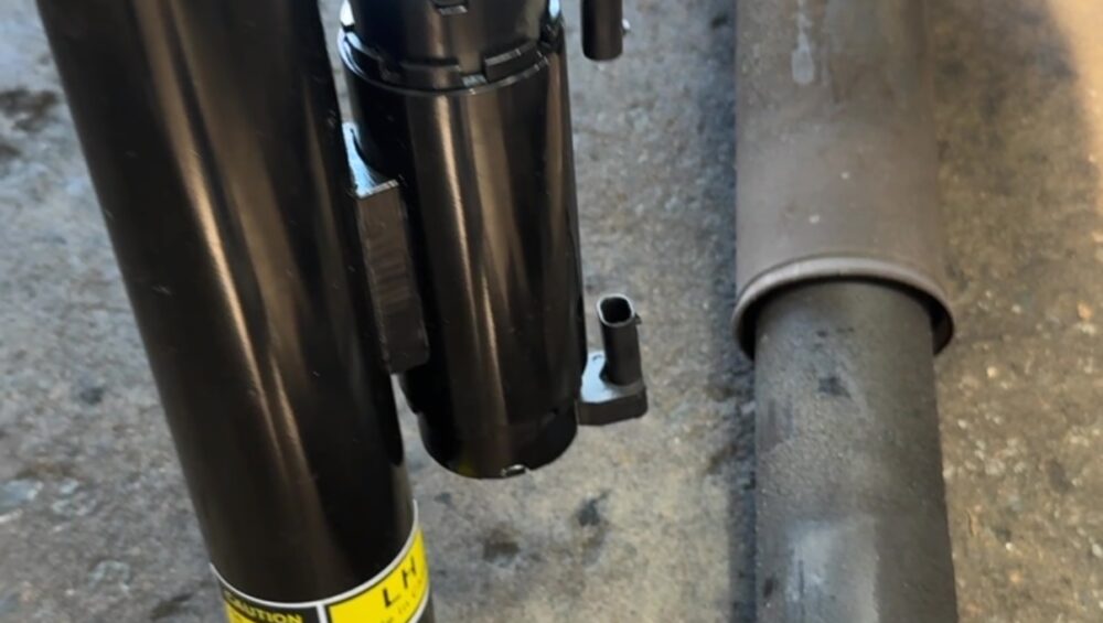 New Mercedes-AMG DampTronic rear shock absorber next to the leaking original