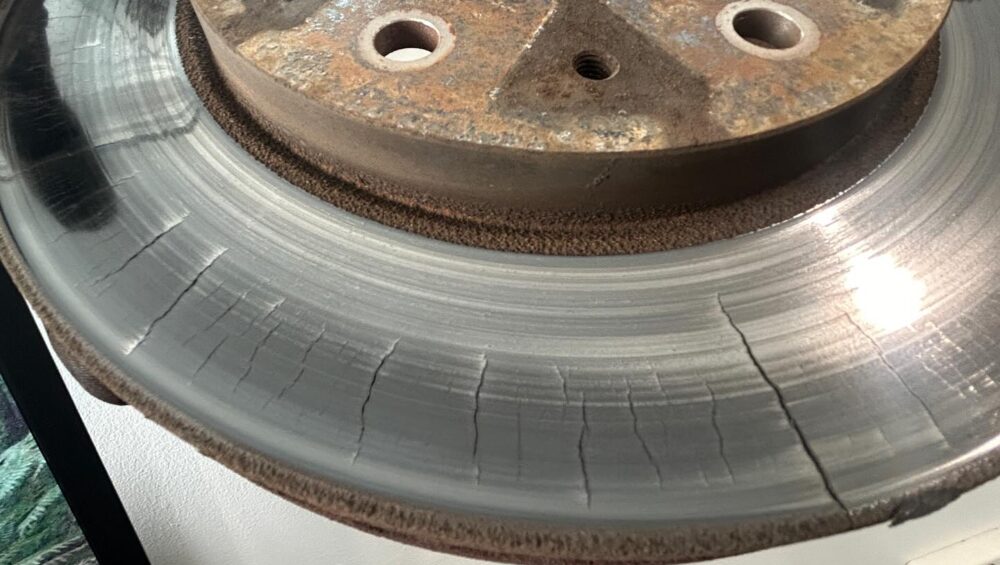 Mitsubishi Triton front brake rotor with heavy heat cracks across the braking surface