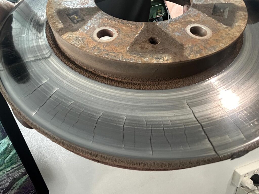 Mitsubishi Triton front brake rotor with heavy heat cracks across the braking surface