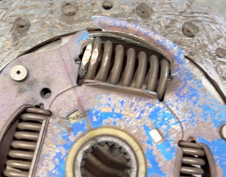 Worn Suzuki Swift clutch plate with a broken damper spring popping out